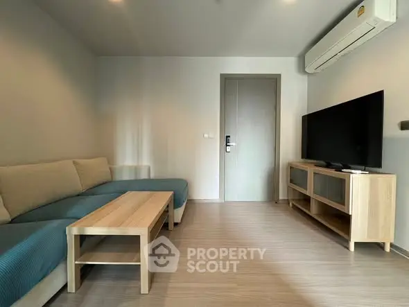 Modern living room with sleek furniture and air conditioning unit