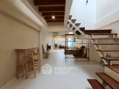 Spacious modern living room with open staircase and stylish decor