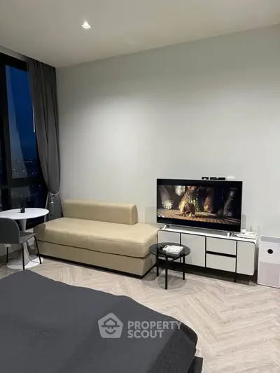 Modern living room with sleek furniture and large window view
