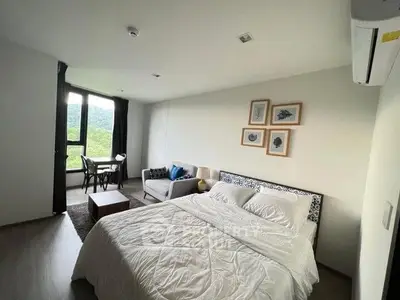 Modern bedroom with scenic view, cozy seating area, and stylish decor.