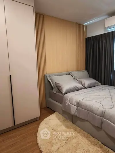 Modern bedroom with stylish wood paneling and cozy bedding