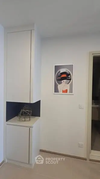 Modern interior with sleek cabinetry and stylish wall art in a contemporary home.