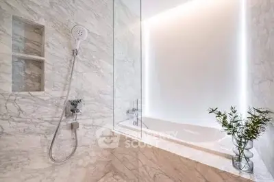 Luxurious marble bathroom with modern shower and elegant bathtub