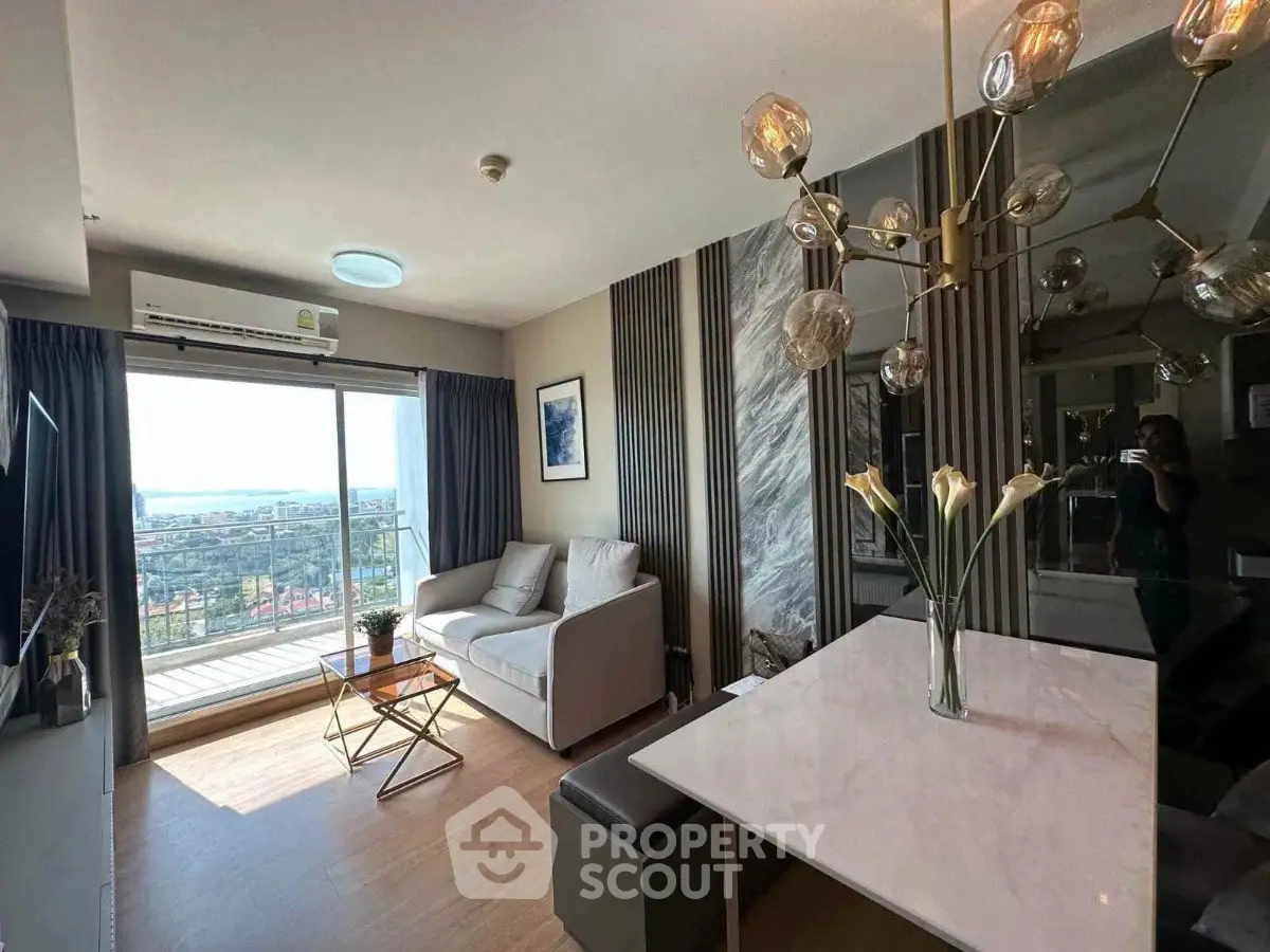 Modern living room with balcony and stylish decor in high-rise apartment