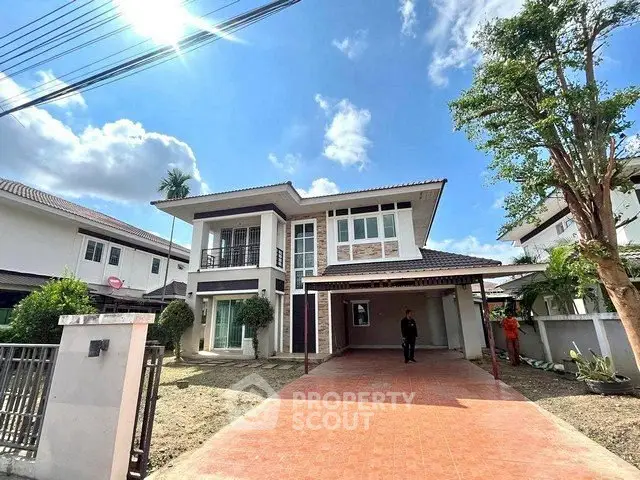 Stunning two-story house with spacious driveway and modern architecture under a clear blue sky.