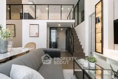 Modern loft apartment with stylish interior, featuring a cozy living area and elegant staircase.