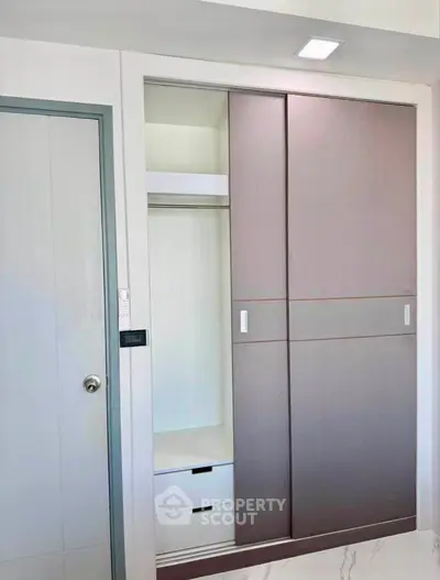 Modern bedroom with sleek built-in wardrobe and minimalist design