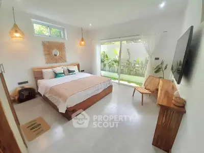 Spacious modern bedroom with natural light and garden view
