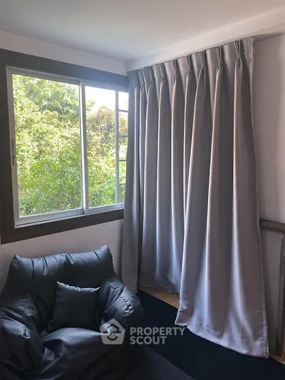 Cozy corner with armchair and window view in modern home interior