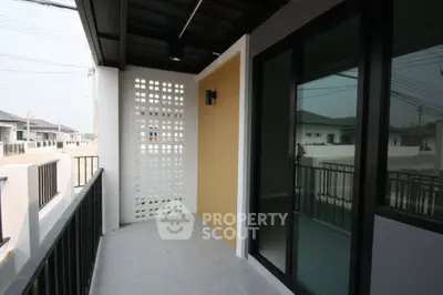 Spacious balcony with modern railing and privacy wall in a contemporary home.