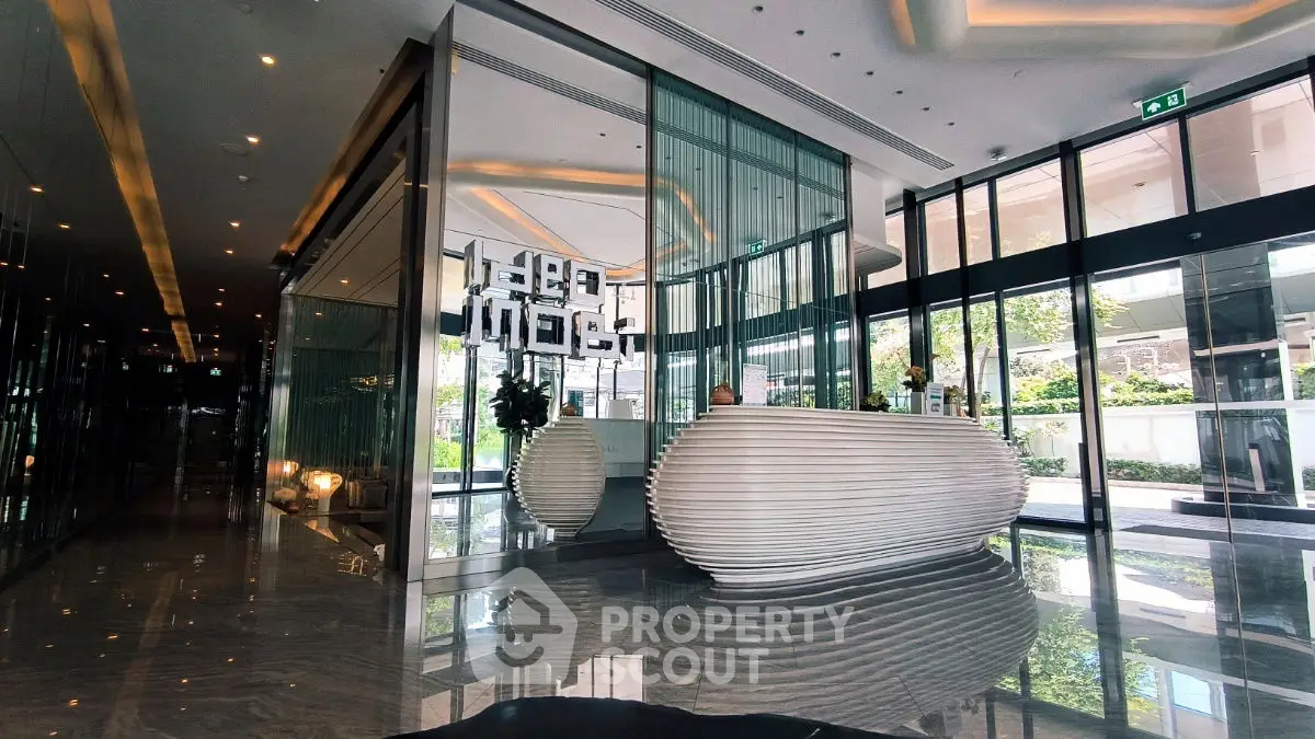 Luxurious modern building entrance with sleek design and reflective surfaces