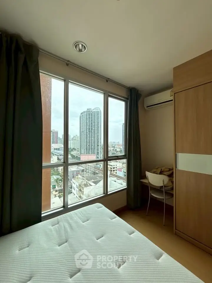 Cozy bedroom with city view and ample natural light