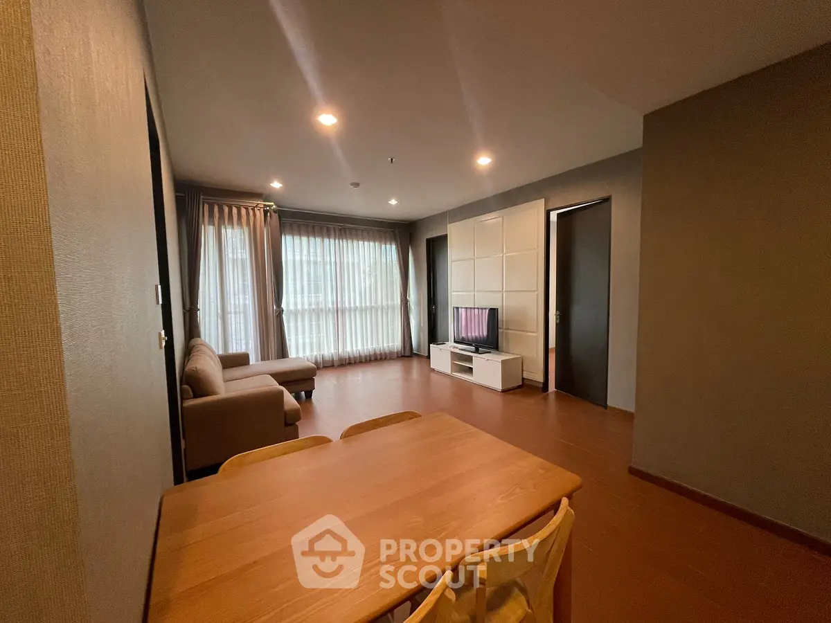 Spacious living room with modern furniture and large windows for natural light.