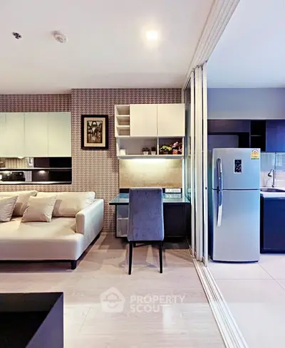 Modern open-plan living room with sleek kitchen and cozy seating area, perfect for urban living.