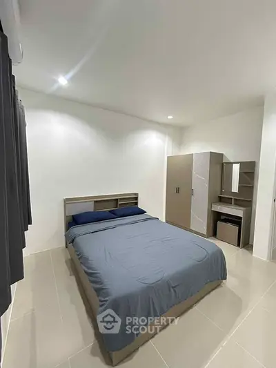 Modern minimalist bedroom with sleek furniture and neutral tones
