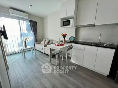 Modern open-layout kitchen and living room with sleek design and natural light