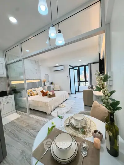 Modern studio apartment with open layout, stylish decor, and balcony access, perfect for urban living.