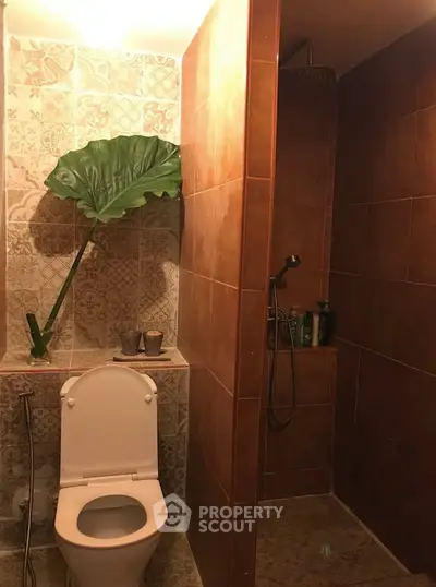 Charming bathroom with unique tile design and modern shower area.