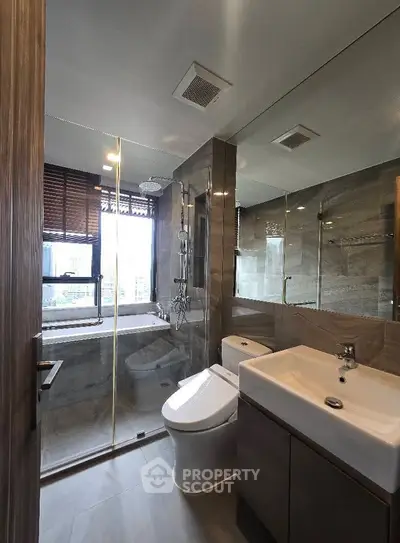 Modern bathroom with glass shower and city view window