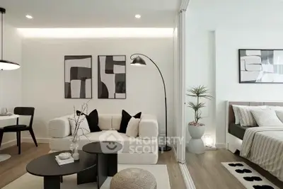 Modern living room with stylish decor and cozy bedroom in open layout apartment.
