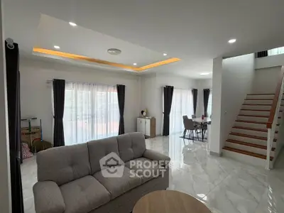 Spacious modern living room with elegant staircase and natural light