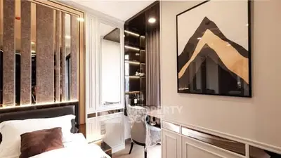 Luxurious bedroom with elegant decor and stylish artwork, featuring a cozy bed and chic study area.