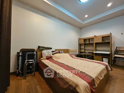 Spacious bedroom with modern furniture and cozy lighting, perfect for relaxation and comfort.