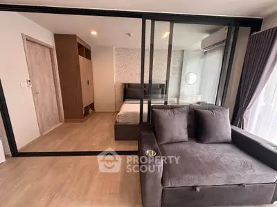 Modern studio apartment with glass partition and cozy furnishings