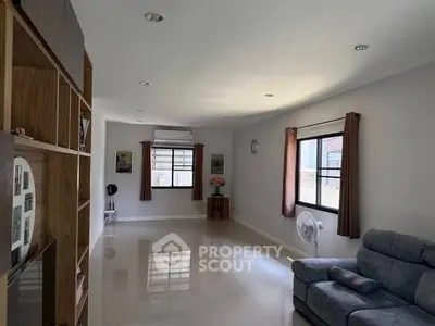 Spacious living room with modern decor and large windows for natural light.