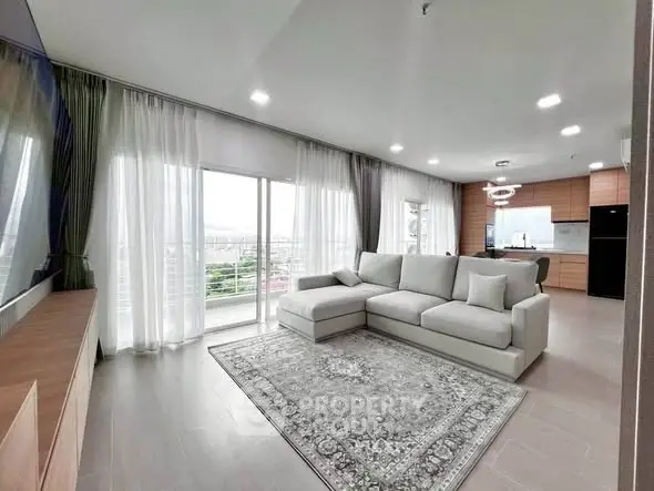 Spacious modern living room with large windows and elegant decor