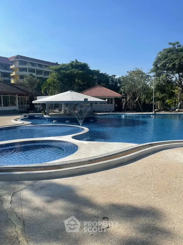 Luxurious outdoor pool area with modern design and lush greenery, perfect for relaxation and leisure.