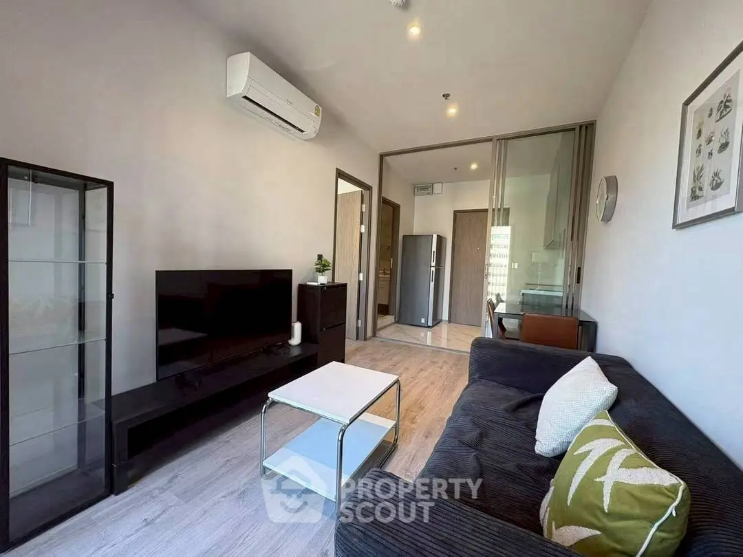 Modern living room with sleek furniture and open layout in a stylish apartment.