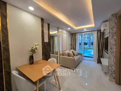 Modern living room with pool view, elegant decor, and cozy seating area.