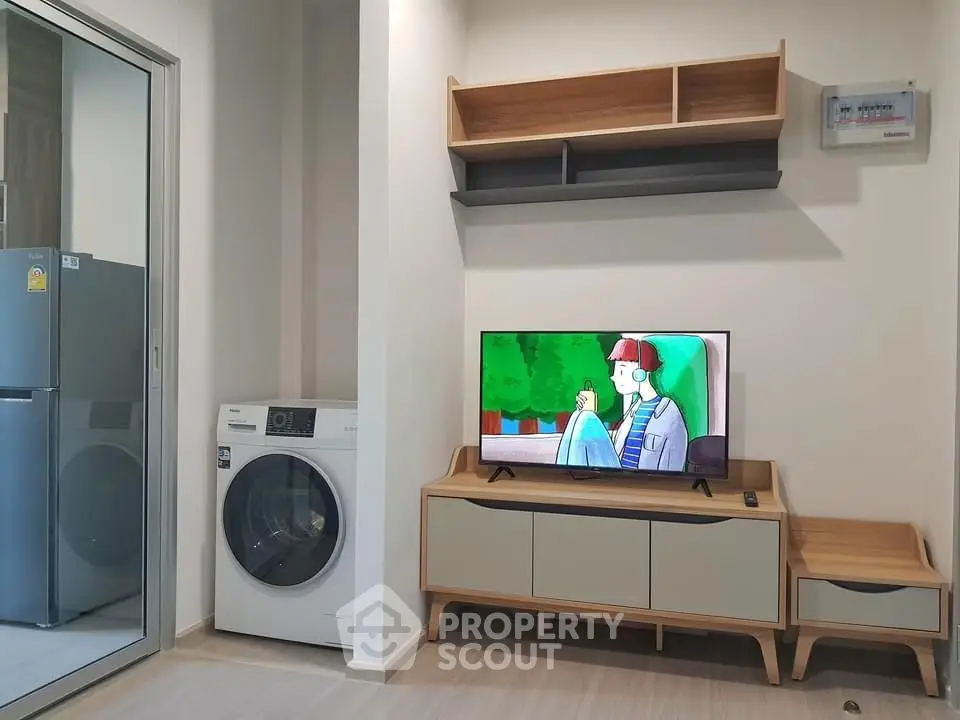 Modern living room with stylish furniture and built-in washing machine, perfect for urban living.