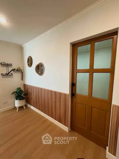 Stylish interior with wooden door and modern decor in a cozy living space.