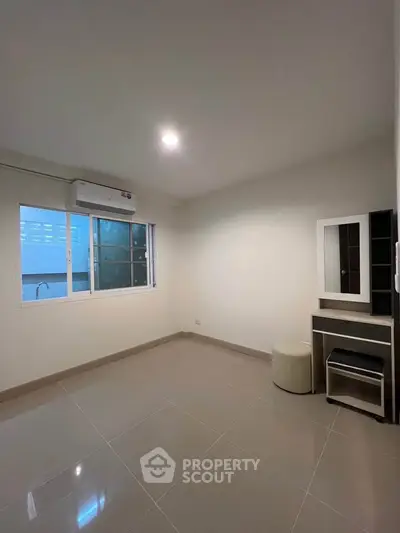 Spacious unfurnished room with large window and tiled flooring, perfect for customization.