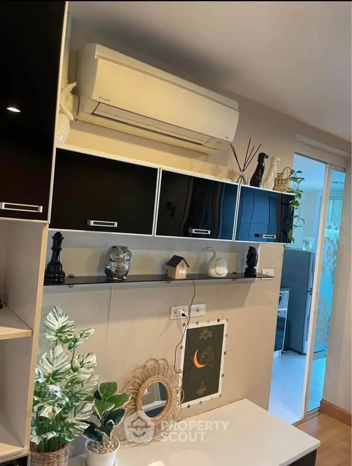 Modern living room with sleek black cabinets and air conditioning unit