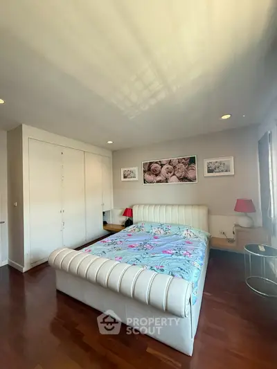 Spacious bedroom with elegant decor and natural light