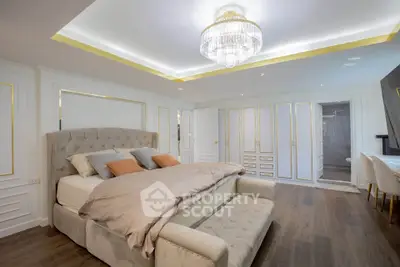 Luxurious bedroom with elegant chandelier and spacious layout