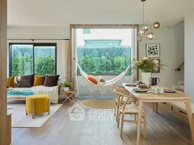 Modern living room with hammock, stylish dining area, and large windows offering lush garden views.