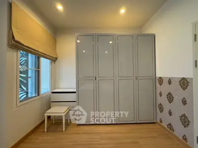 Spacious bedroom with modern wardrobe and elegant decor