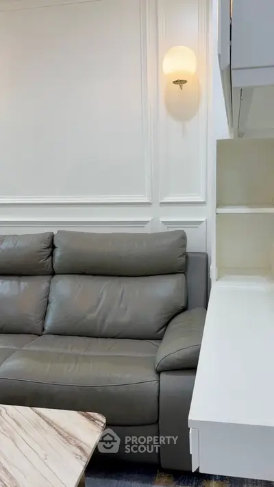 Modern living room with stylish leather sofa and elegant wall lighting
