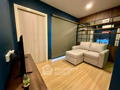 Modern living room with sleek design, cozy sofa, and stylish shelving unit.