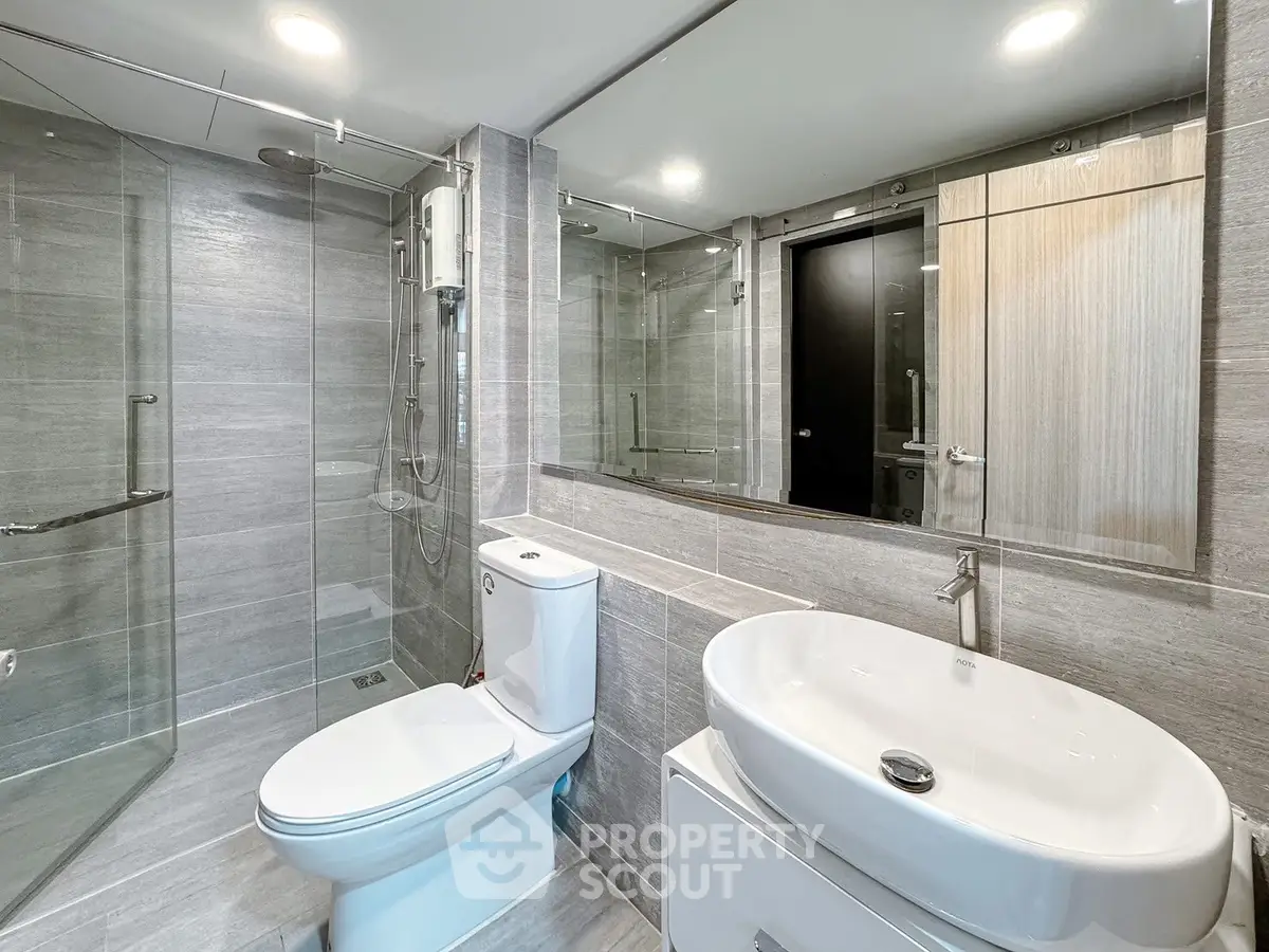 Modern bathroom with sleek fixtures and glass shower enclosure