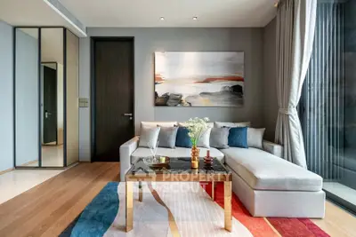 Modern living room with stylish decor, large window, and comfortable seating in a contemporary apartment.