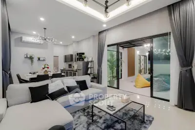 Luxurious modern living room with open layout and stylish decor, featuring plush sofa and elegant lighting.