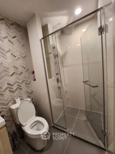 Modern bathroom with glass shower and stylish tile design