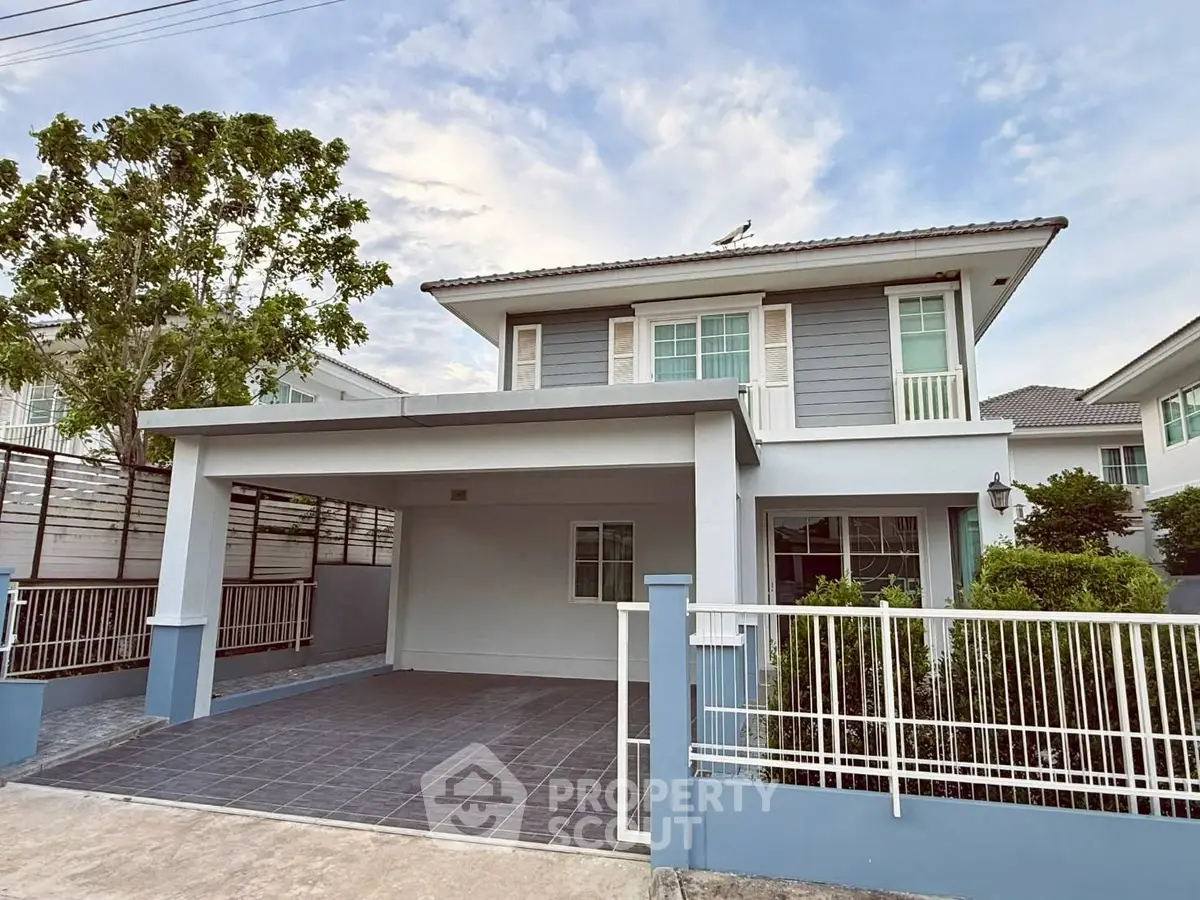 Charming two-story house with spacious driveway and modern exterior design in a serene neighborhood.