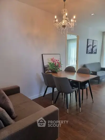 Elegant dining area with chandelier and modern decor in a cozy living space.