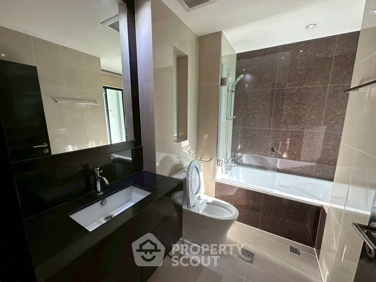 Modern bathroom with sleek fixtures and bathtub in contemporary apartment